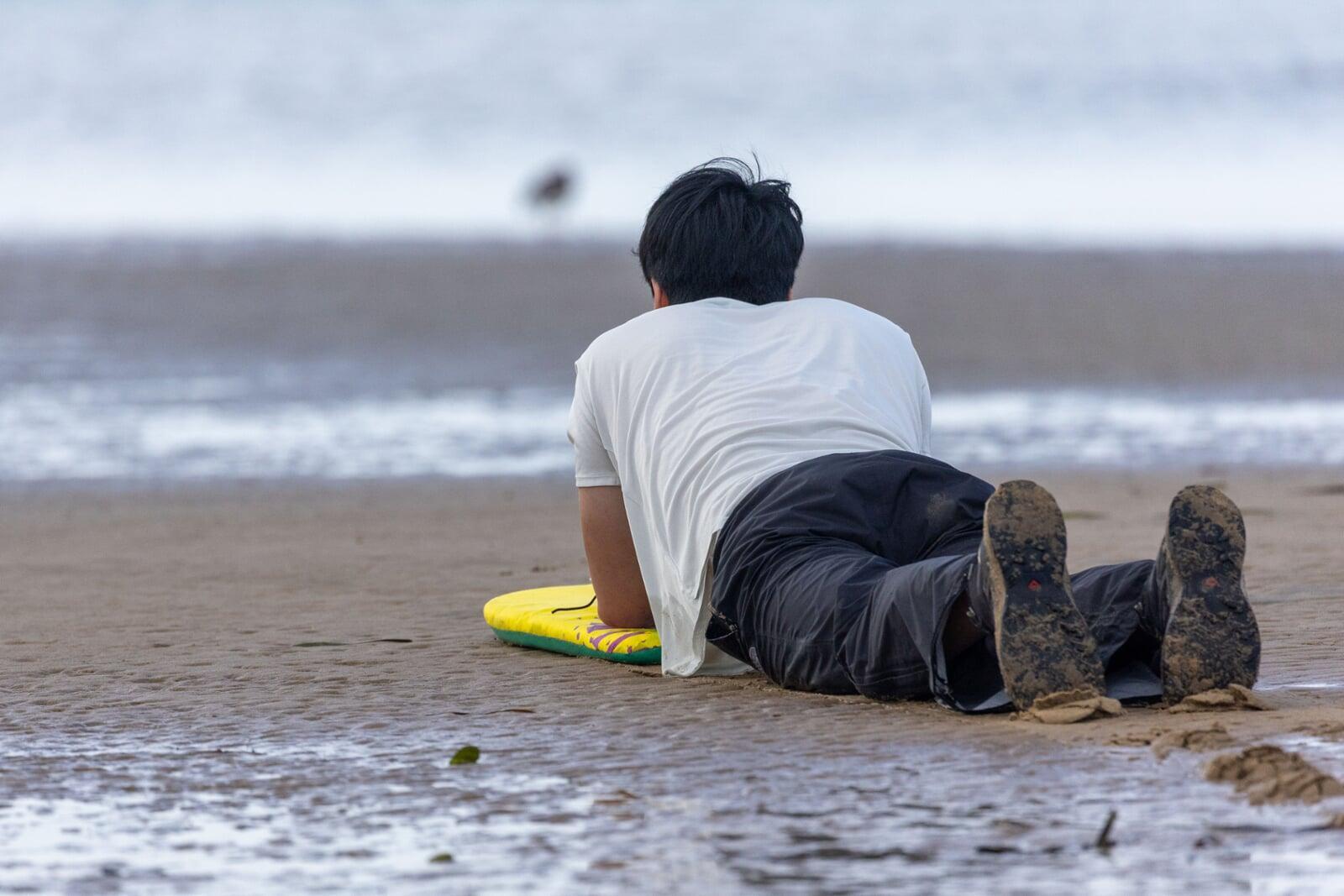 A person using a TalonFab StridePod on a bodyboard to smoothly approach a wading bird